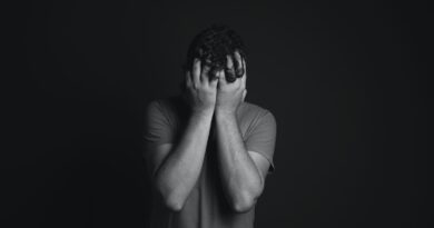 Gray scale Photo of Man Covering Face With His Hands