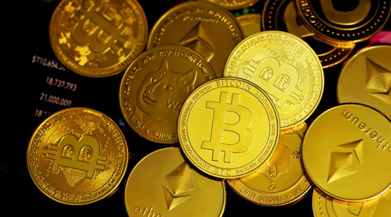 a pile of gold bitcoins sitting on top of each other