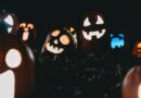 a group of carved pumpkins with glowing faces
