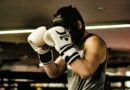 a man wearing a white and black boxing glove