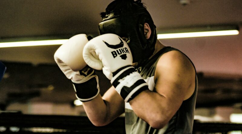 a man wearing a white and black boxing glove