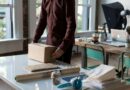 person holding cardboard box on table