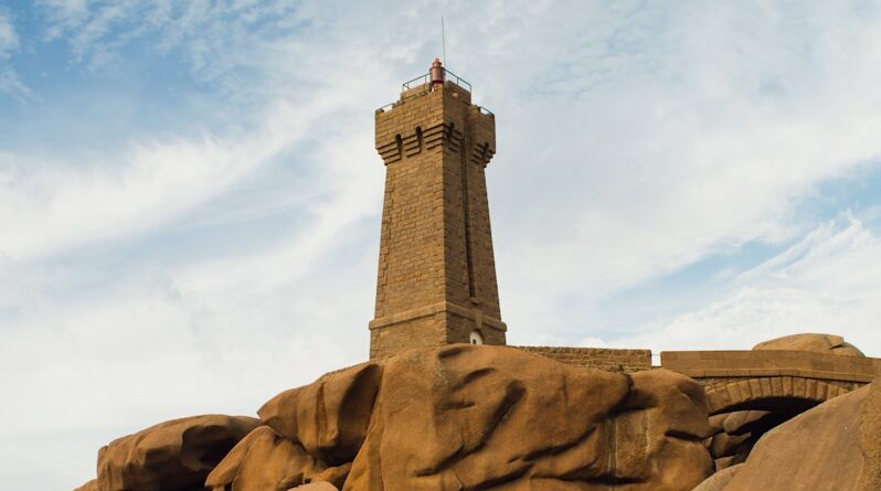 a lighthouse on top of a rocky outcropping