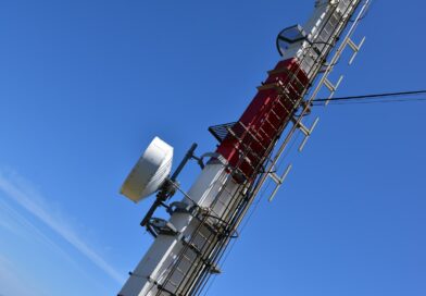 a cell phone tower with a lot of antennas on top of it