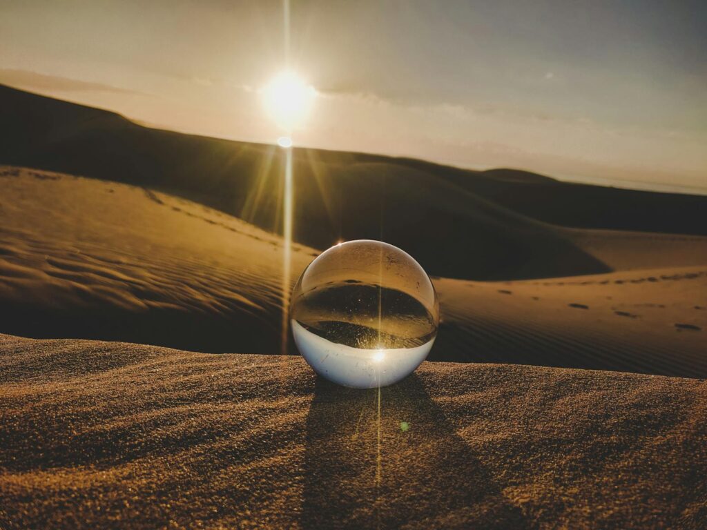 A crystal ball reflecting sunlight on desert dunes, captured in Lanzarote, Spain.