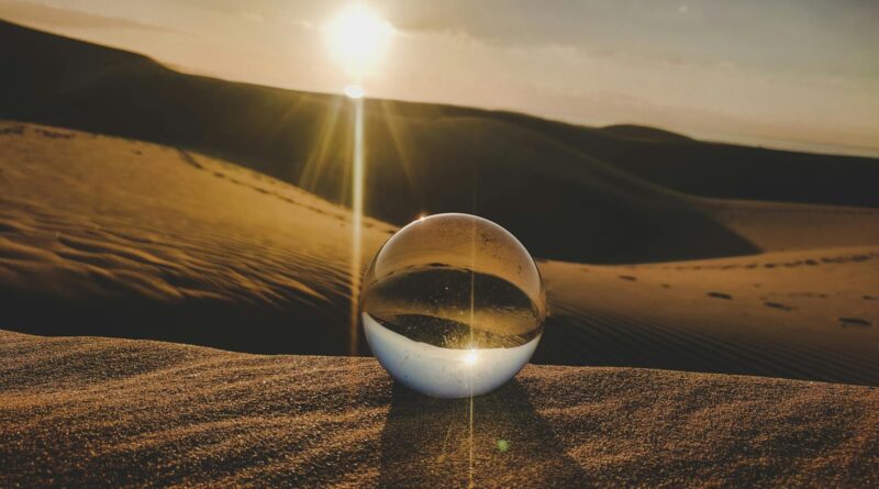 A crystal ball reflecting sunlight on desert dunes, captured in Lanzarote, Spain.