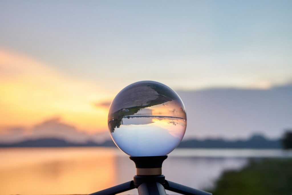 clear glass ball on black metal fence during daytime