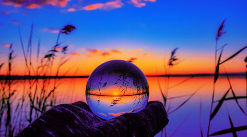 person holding ball during sunset