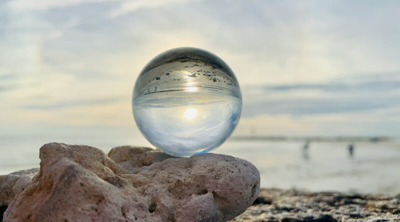 clear glass ball on brown rock