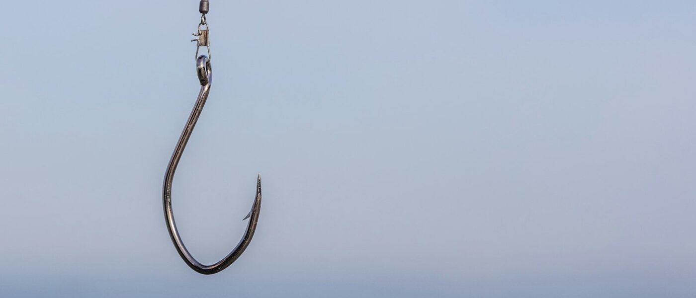 a fishing hook hanging from the side of a boat